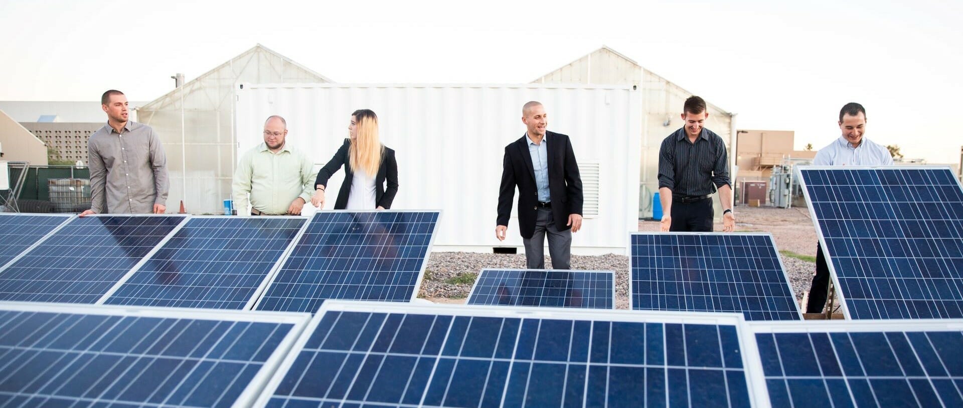 solarpanel farm and group onlooking and admiring